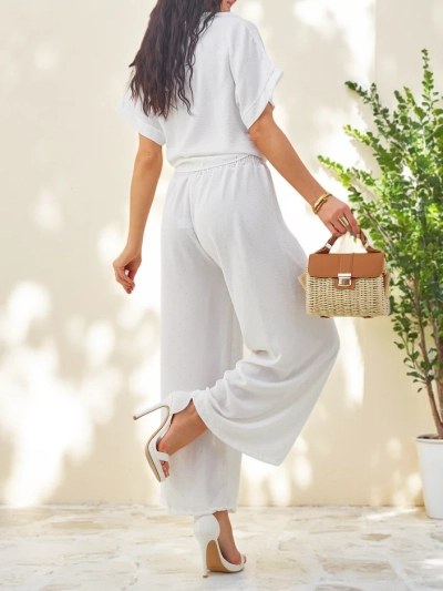 Ensemble Royalfashion pour femmes avec une chemise à manches courtes nouée et un pantalon évasé orné de strass